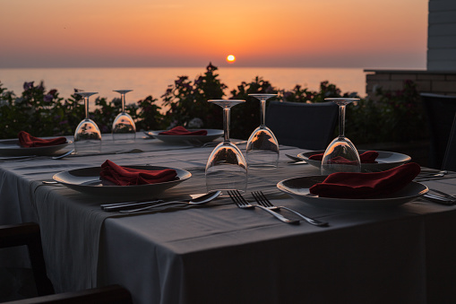Empty restaurant with beautiful colorful sunset sky, sea view at the beach. Resort restaurant.