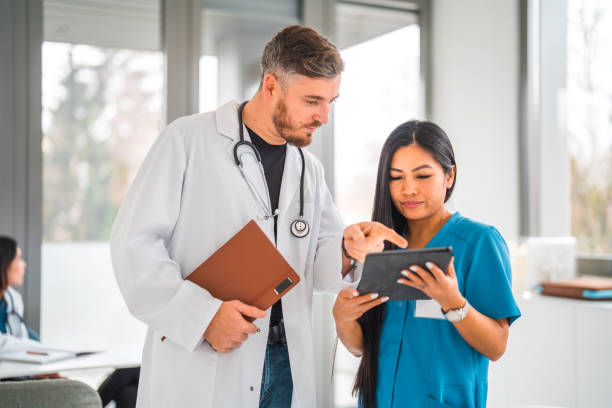 istock Mid Adult Chinese Female Nurse Using Wireless Technology 1802156737