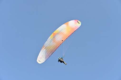 Motor powered paraglider on clear blue sky background, popular leisure activities on Kamchatka