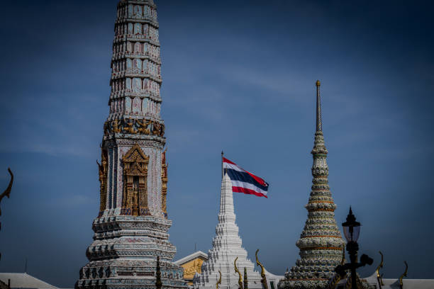 The Thailand National Flag is seen waving at the Grand Palace in Bangkok. Daily life in Bangkok, Thailand as the Thai Government pushes for growth in the international tourism market, recently enacting visa-free entry programs to the Kingdom for international tourists from Russia, China, and India.