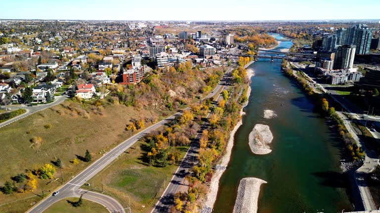 Prince's Island Park autumn foliage scenery. Aerial view of Downtown City of Calgary Centre St Bridge