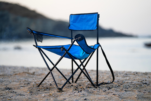 Pet dog shih tzu sitting on camping chair looking in the morning