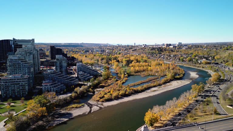 Prince's Island Park autumn foliage scenery. Aerial view of Downtown City of Calgary Centre St Bridge