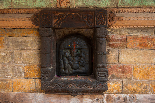 Beautiful stone wall carvings done in the exterior wall of the ancient temple in Tamilnadu.