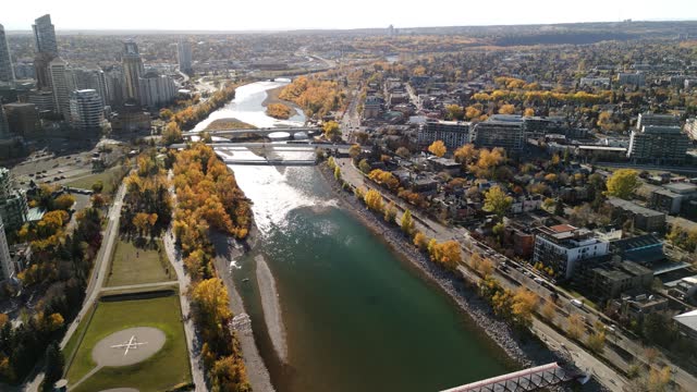 Prince's Island Park Peace Bridge autumn foliage scenery. Aerial view of Downtown City of Calgary