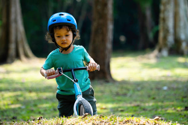 istock boy driving balance bike outdoors on forest 1802212901