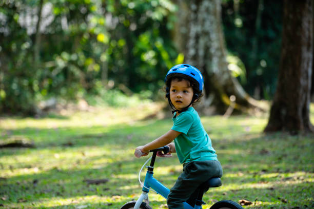 istock boy driving balance bike outdoors on forest 1802213945