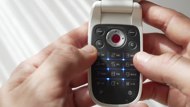 Using an old-fashioned push-button flip mobile phone