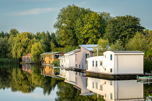 Houseboats reflected in water surface
