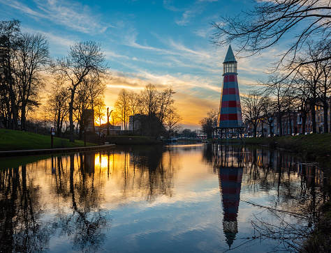 Autumn scene with lighthouse by the canal in dutch city of Breda