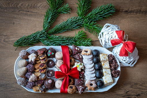 Plate with variety of traditional czech homemade christmas cookies displayed on wooden table