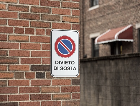 An image of a street sign mounted on a brick wall