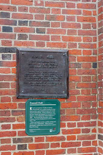 The Freedom Trail signs on the outside of Faneuil House, Boston, Massachusetts, USA.