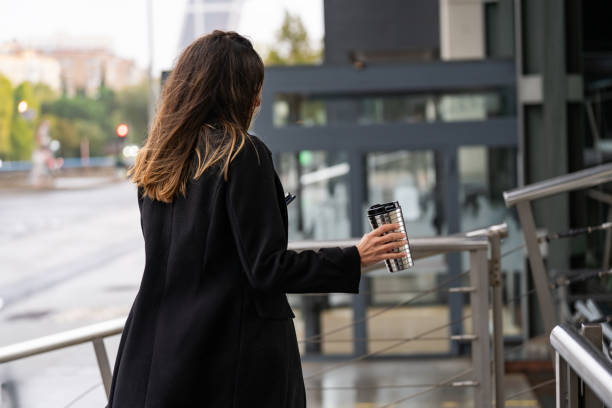 Back view, stylish woman, coffee stroll.