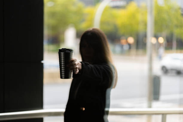 istock Autumnal silhouette: girl, coffee thermos, reflections. 1802280849