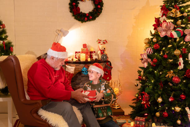 istock kid boy grandchild open gift box surprise from grandfather 1802281402