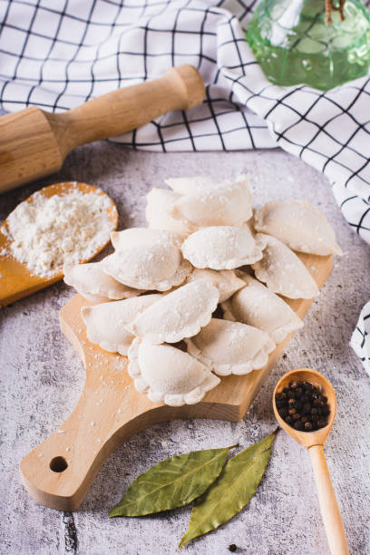 istock Frozen raw dumplings with potatoes on a cutting board on the table vertical view 1802286174