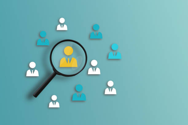 istock Magnifier glass focus on the yellow human icon for a select employee 1802287807