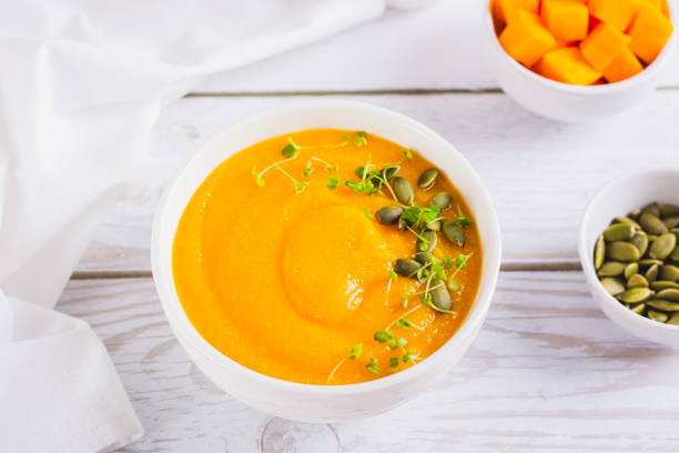 istock Corn porridge with pumpkin puree and microgreens in a bowl on the table 1802293799