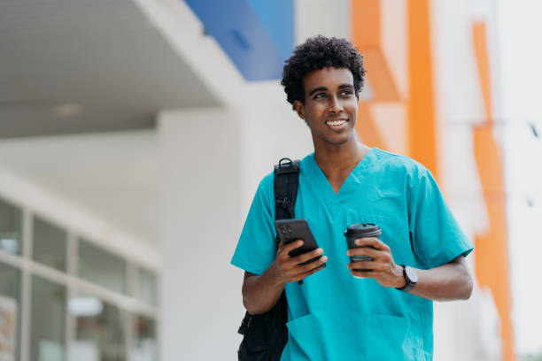 istock Young African healthcare worker walking to work 1802298017