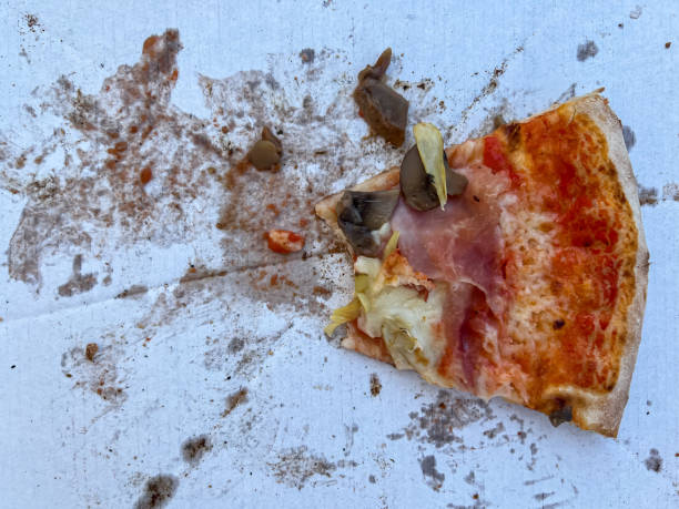 istock The last bitten slice of pizza on a cardboard box 1802299095