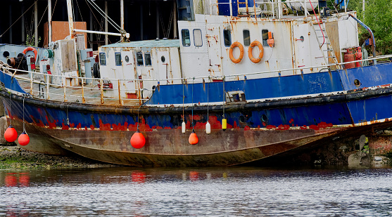 Old steel blue boat moored in the west coast highlands, Scotland, UK