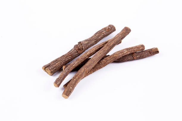 istock Liquorice root isolated on white background 1802317590
