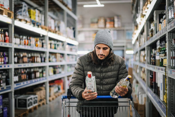 man in a liquor store. - eastern european caucasian one person alcoholism imagens e fotografias de stock