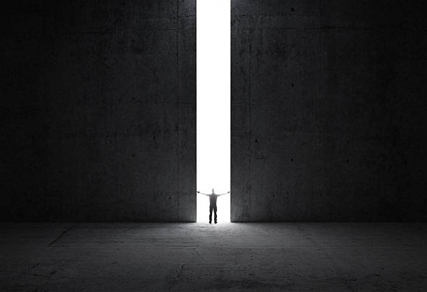 istock Man stands in the light of opening 180233152
