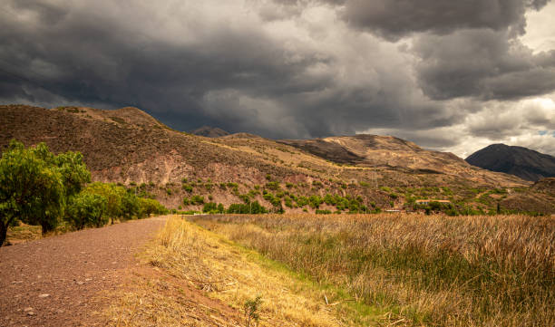 istock dirt road with rain clouds in the background 1802340808