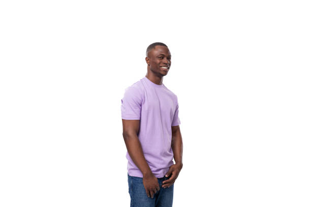 istock young authentic slender american guy dressed in light lilac t-shirt and jeans 1802342336