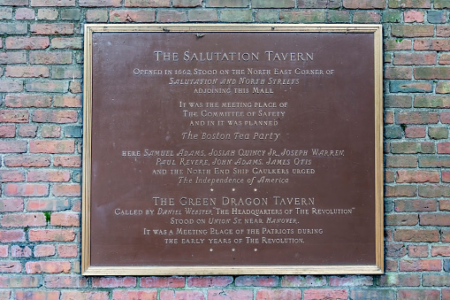 Sign on the wall of Paul Revere's Mall beside Old North Church, this sign gives details of The Salutation Tavern where the Boston Tea Party was planned in Boston, Massachusetts, USA.