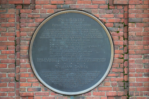 Sign on the wall of Paul Revere's Mall beside Old North Church, this sign gives details of Paul Revere and William Dawes. Boston, Massachusetts, USA.