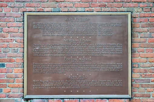 Sign on the wall of Paul Revere's Mall beside Old North Church, this sign gives details of John Winthrop, Nicholas Upsall, Cotton Mather and John Hull in Boston, Massachusetts, USA.