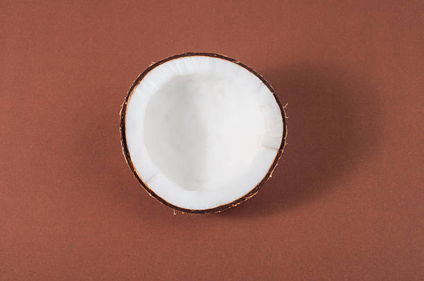 istock halfs of coconut  on background with shadow 180235648
