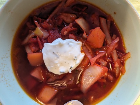 Portion of Russian beetroot soup- borshtsch served with creme fresch.