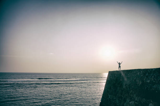 Unrecognizable and silhouetted person on Flag Rock, Galle, Sri Lanka.