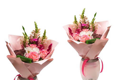 Bouquet of  soft pink flowers in pink wrapping paper. Isolated on a white background.