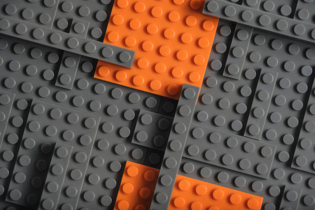 istock Abstract gray orange background from plastic building block children designer. 1802375651