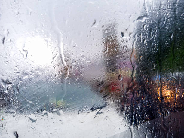 istock rainy background with flowing down water on glass 1802385865