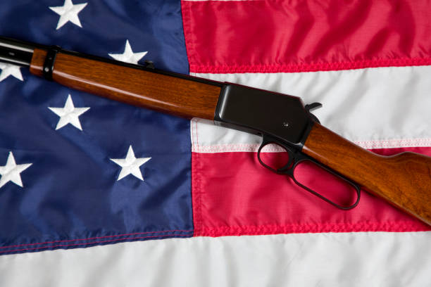 U.S. Second Amendment constitutional Right to Bear Arms. Lever action rifle resting on American Flag.