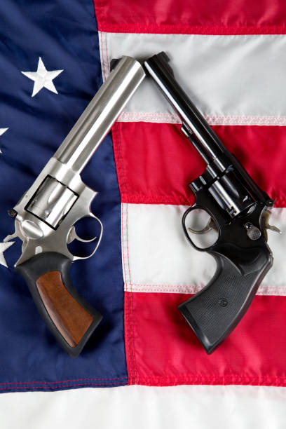 istock Revolvers resting on American Flag background 1802389655