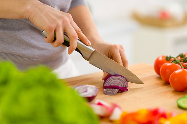 istock Closeup on woman cutting onion 180240540