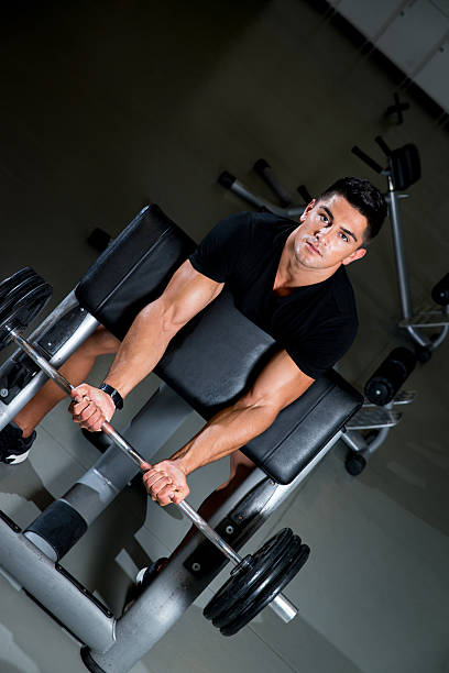 istock Handsome muscular man exercising in Gym 180240959