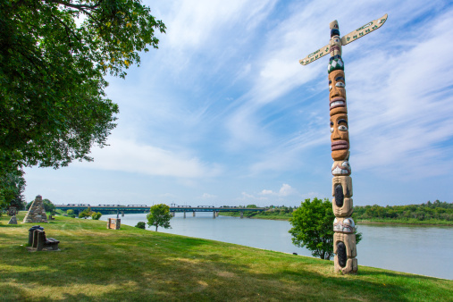 A totem pole in the park along the river