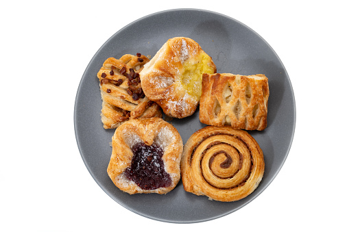 A selection of French pastries on a plate - white background