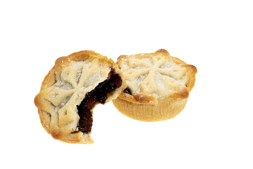 Two mince pies, one with a bite taken from it - white background