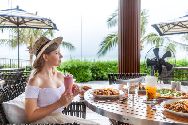 istock Beach resort dining experience, woman contemplates ocean view 1802433964