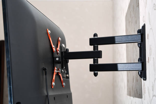 istock Swivel TV bracket LED display. Back view. X-shaped red fasteners. Black color. Multiplanar. Hangs on a wall. Reliable and comfortable fastening. Childproof and rollover protection. Metallic equipment 1802442858