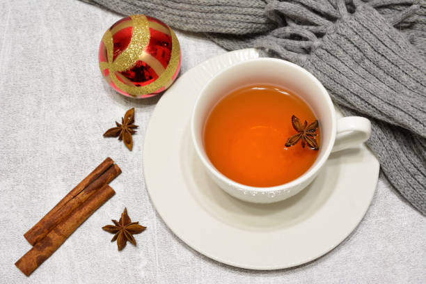 istock hot tea with cinnamon and badian decorated with scarf and red sphere 1802443935